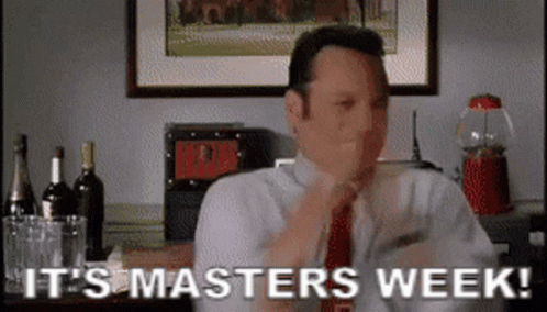 A Man In A Suit And Tie Is Sitting At A Table And Says It 'S Masters Week . GIF