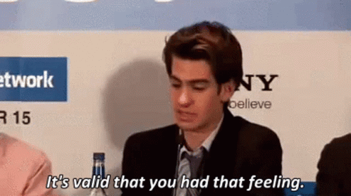 A Man In A Suit And Tie Is Sitting At A Table And Says `` It 'S Valid That You Had That Feeling . '' GIF