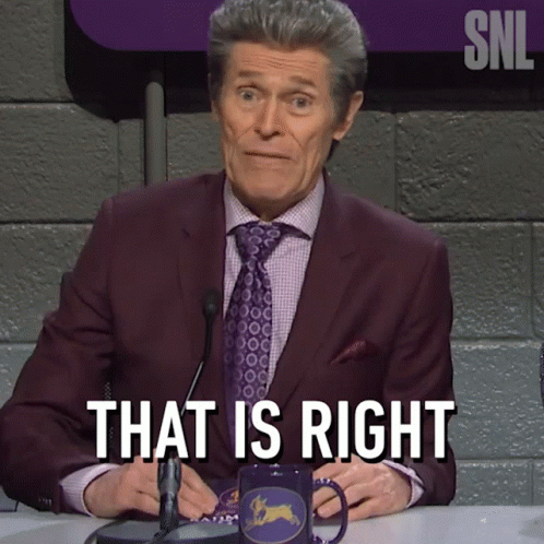 A Man In A Suit And Tie Is Sitting At A Table And Says That Is Right GIF