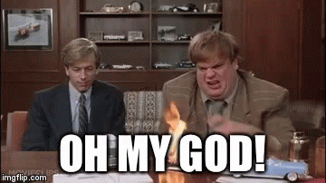 A Man In A Suit And Tie Is Sitting At A Table With A Toy Car On It And Says Oh My God . GIF
