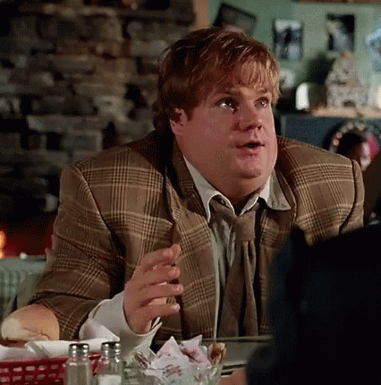 A Man In A Suit And Tie Is Sitting At A Table With Salt And Pepper Shakers GIF