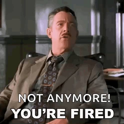 A Man In A Suit And Tie Is Sitting In A Chair And Saying `` Not Anymore ! You 'Re Fired '' . GIF