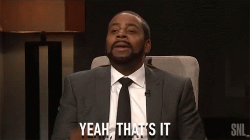 A Man In A Suit And Tie Is Sitting In A Chair And Saying Yeah That 'S It GIF