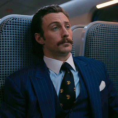 Man In Suit And Tie Sitting In Chair GIF