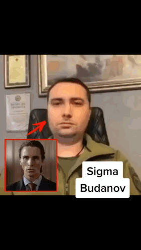 A Man In A Suit And Tie Is Sitting In A Chair Next To A Picture Of A Man Named Sigma Budenov GIF