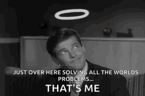 A Man In A Suit And Tie Is Sitting In A Chair With A Halo On His Head . GIF