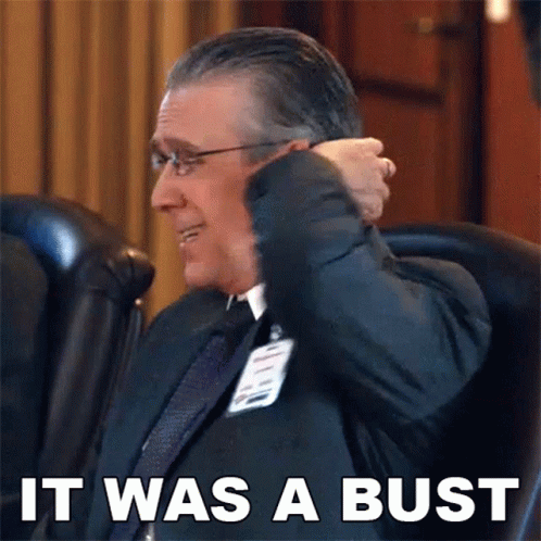 A Man In A Suit And Tie Is Sitting In A Chair With The Words " It Was A Bust " Above Him GIF