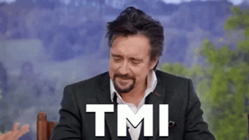A Man In A Suit And Tie Is Sitting In A Chair With The Words Tmi Written On His Face . GIF