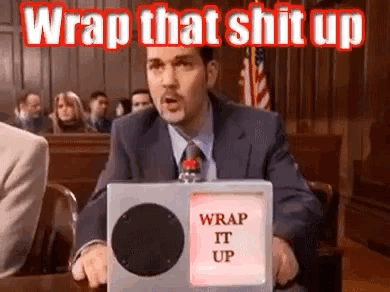 A Man In A Suit And Tie Is Sitting In A Courtroom Holding A Box That Says `` Wrap That Shit Up '' . GIF