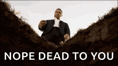 A Man In A Suit And Tie Is Sitting In A Grave With The Words Nope Dead To You Above Him . GIF
