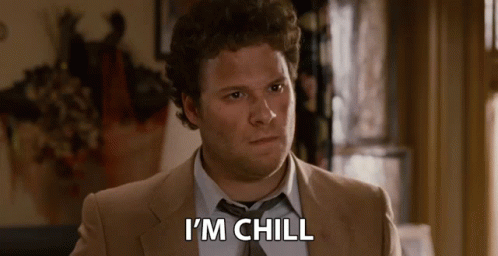 A Man In A Suit And Tie Is Sitting In A Room And Saying I 'M Chill . GIF