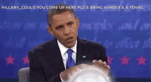 A Man In A Suit And Tie Is Sitting In Front Of A Blue Background With The Words Hillary Could You Come Up Here GIF