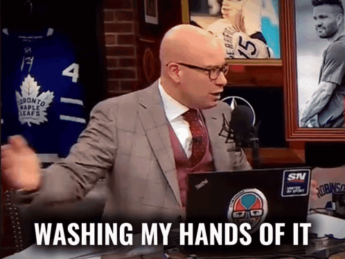 A Man In A Suit And Tie Is Sitting In Front Of A Laptop With The Words Washing My Hands Of It On It GIF