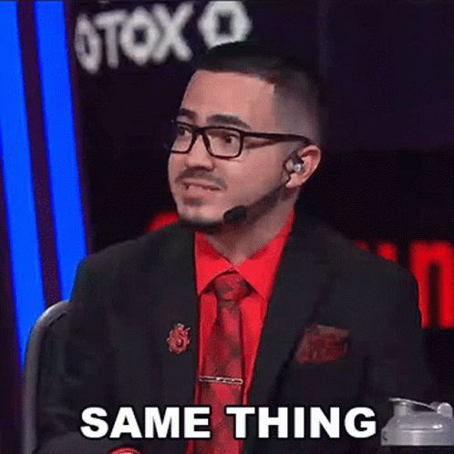 A Man In A Suit And Tie Is Sitting In Front Of A Microphone And Says Same Thing . GIF