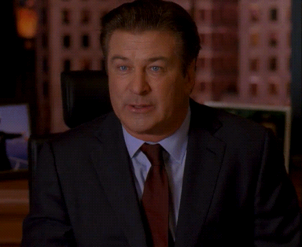 A Man In A Suit And Tie Is Sitting In Front Of A Screen That Says Request Denied GIF