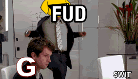 A Man In A Suit And Tie Is Sitting In Front Of A White Board With The Words Fud G And $ Wit GIF
