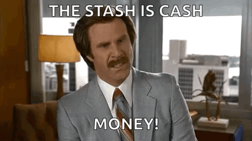 A Man In A Suit And Tie Is Sitting In Front Of A Window And Saying `` The Stash Is Cash Money '' . GIF