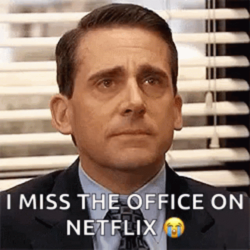 A Man In A Suit And Tie Is Sitting In Front Of A Window With Blinds And Crying . GIF