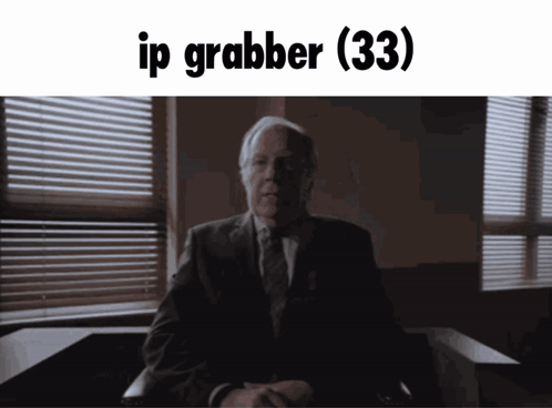 A Man In A Suit And Tie Is Sitting In Front Of A Window With The Words Ip Grabber ( 33 ) Written Above Him GIF