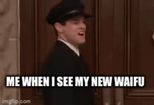 A Man In A Suit And Tie Is Sitting In Front Of A Wooden Door . GIF