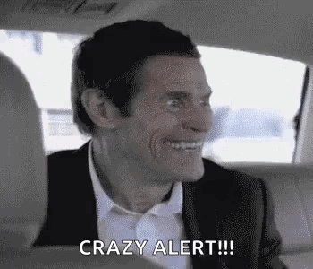 A Man In A Suit And Tie Is Sitting In The Back Seat Of A Car . GIF