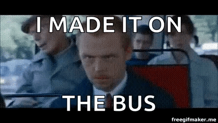 A Man In A Suit And Tie Is Sitting On A Bus And Making A Funny Face . GIF