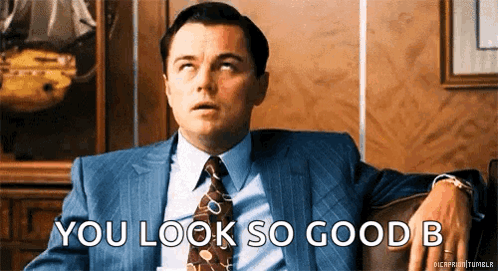 A Man In A Suit And Tie Is Sitting On A Couch Saying You Look So Good B GIF