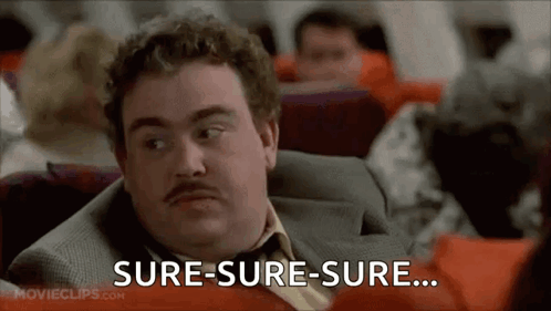 A Man In A Suit And Tie Is Sitting On An Airplane And Says Sure-Sure-Sure . GIF