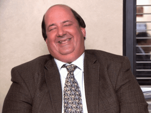 A Man In A Suit And Tie Is Smiling GIF