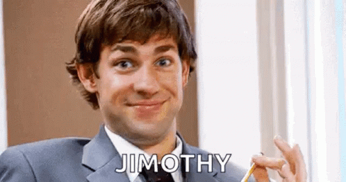 A Man In A Suit And Tie Is Smiling And Holding A Pencil In His Hand . GIF