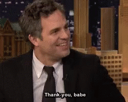 A Man In A Suit And Tie Is Smiling And Saying Thank You Babe GIF