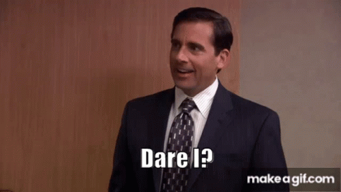 A Man In A Suit And Tie Is Smiling And Says Dare I ? GIF