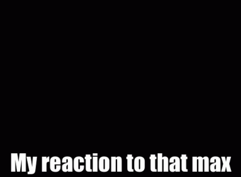 a man in a suit and tie is smiling and says my reaction to that max