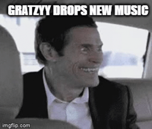 A Man In A Suit And Tie Is Smiling In A Car . GIF