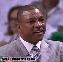 A Man In A Suit And Tie Is Smiling In Front Of A Banner That Says Sbnation GIF