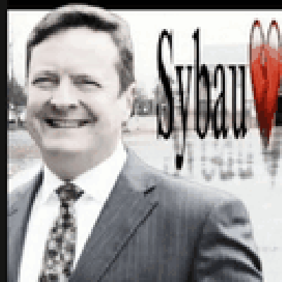 A Man In A Suit And Tie Is Smiling In Front Of A Sybau Logo GIF