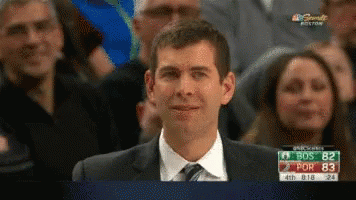 A Man In A Suit And Tie Is Smiling While Watching A Game On Nbc Sports GIF