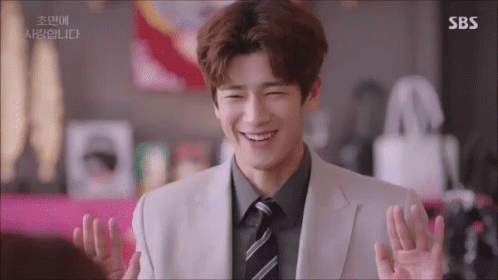 a man in a suit and tie is smiling with sbs written on the bottom