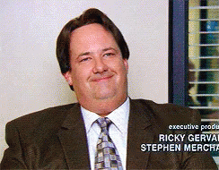 A Man In A Suit And Tie Is Smiling With The Name Ricky Gervais On The Bottom GIF