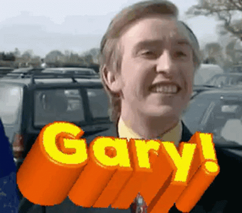 A Man In A Suit And Tie Is Smiling With The Word Gary Above Him GIF