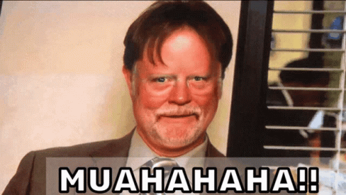A Man In A Suit And Tie Is Smiling With The Words Muahaha Written Below Him GIF