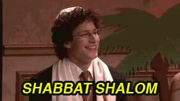 A Man In A Suit And Tie Is Smiling With The Words Shabbat Shalom Above Him GIF