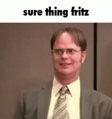A Man In A Suit And Tie Is Smiling With The Words `` Sure Thing Fritz '' Written Above Him . GIF