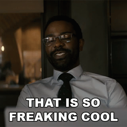 A Man In A Suit And Tie Is Smiling With The Words That Is So Freaking Cool Below Him GIF