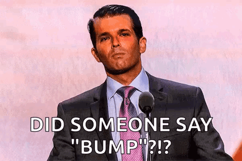 A Man In A Suit And Tie Is Speaking Into A Microphone And Says Did Someone Say " Bump " GIF