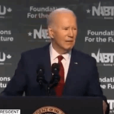 Man In Suit And Tie Giving Speech At Podium GIF