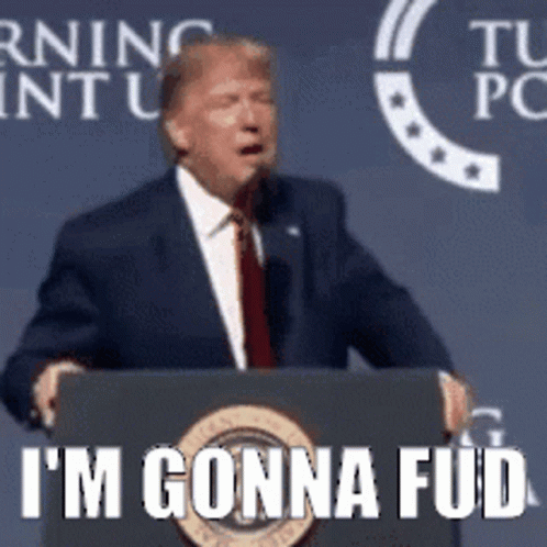 A Man In A Suit And Tie Is Standing At A Podium And Says I 'M Gonna Fud . GIF