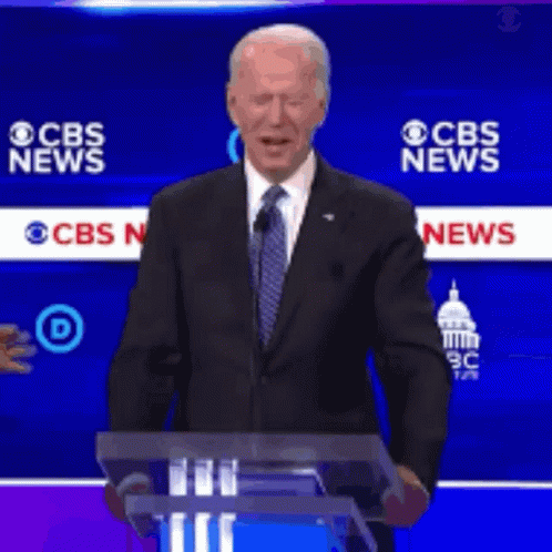 Man In Suit At Podium With CBS News GIF