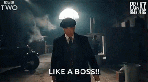 A Man In A Suit And Tie Is Standing In A Dark Room Holding A Knife And Says `` Like A Boss '' . GIF