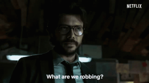 A Man In A Suit And Tie Is Standing In A Dark Room With Netflix Written In The Corner GIF